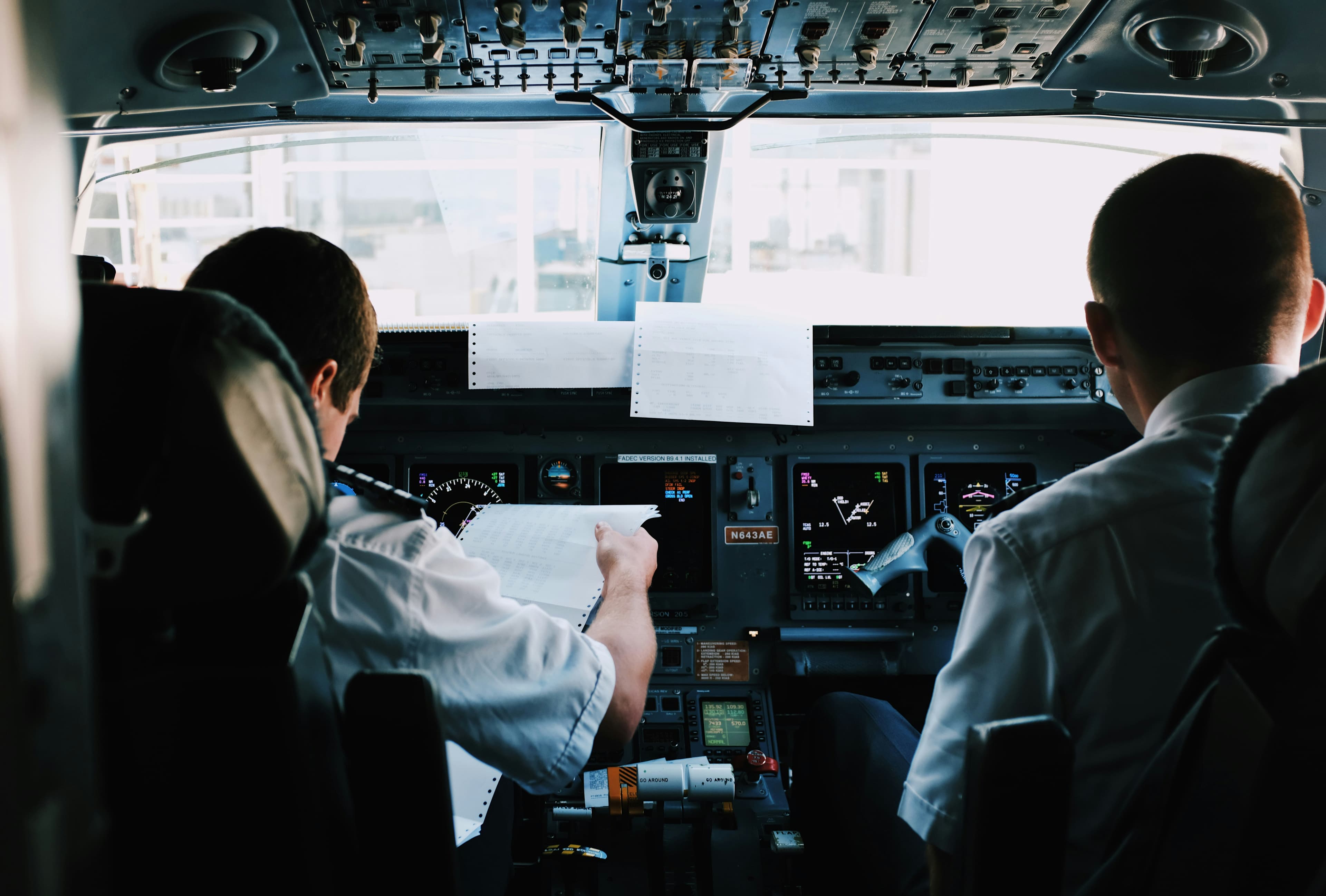 Aviation professionals ready to join - modern aircraft cockpit with blue sky view